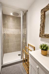 a bathroom with a shower with a glass door at Aux Matins du Bonheur in Surzur +27 photos