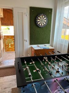 a room with a dart board and a table with a dart board at A-BB-LAK in Hajdúszoboszló