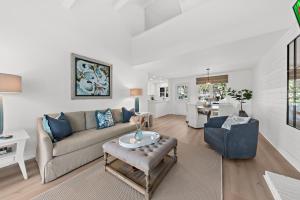 a living room with a couch and a table at 542 Tarpon Pond Cottage in Seabrook Island