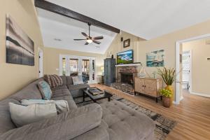 a living room with a couch and a fireplace at 515 Tarpon Pond Cottage in Seabrook Island