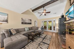a living room with a couch and a tv at 515 Tarpon Pond Cottage in Seabrook Island