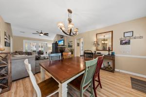 a dining room and living room with a table and chairs at 515 Tarpon Pond Cottage in Seabrook Island +20 photos