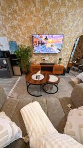a living room with a couch and a flat screen tv at Pinnacle Homes 254 - Ruaka in Ruaka