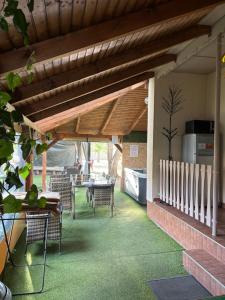 a patio with a table and chairs under awning at A-BB-LAK in Hajdúszoboszló