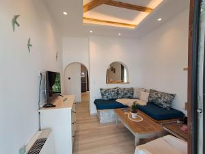 a living room with a couch and a table at Aegean Infinite View-Beachfront Suite Pelion in Chorefto