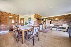 a kitchen and dining room with a table and chairs at Cutbush Farmhouse in Norwich