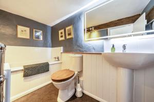a bathroom with a toilet and a sink at Cutbush Farmhouse in Norwich +38 photos