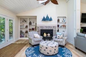 a living room with two chairs and a fireplace at 2932 Captain Sams in Johns Island +30 photos
