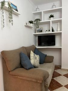a living room with a couch and a tv at Casas PARAJE NATURAL in Zahara de la Sierra