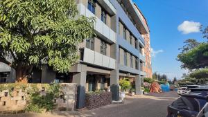 a building with cars parked in front of it at The Luke Hotel - Roasters in Nairobi