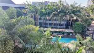 an overhead view of a resort with palm trees and a swimming pool at The Luke Hotel - Roasters in Nairobi