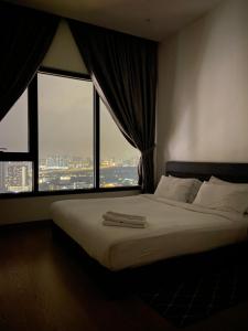 a bedroom with a large bed with a large window at Luxury Suites By Lucentia Residence BBCC Kuala Lumpur in Kuala Lumpur +114 photos