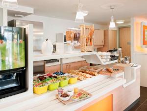 a kitchen with a counter with food on it at ibis budget Istres Trigance in Istres
