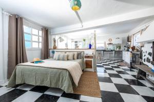 a bedroom with a bed and a checkered floor at Vista Paraiso, Sea breeze facing the sea in La Oliva