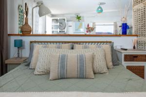 a bed with pillows on it in a bedroom at Vista Paraiso, Sea breeze facing the sea in La Oliva