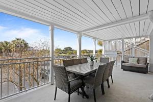 a patio with a table and chairs on a balcony at 2943 Atrium Villa in Seabrook Island