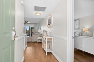 a hallway with white walls and a table in a room at 2943 Atrium Villa in Seabrook Island +36 photos