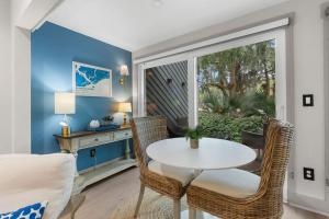 a dining room with a table and chairs and a window at 620 Shadowwood in Seabrook Island