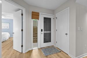 an empty room with white walls and a sliding door at 1807 Heron Pt in Seabrook Island