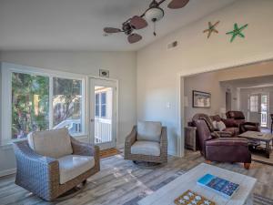 a living room with a couch and a chair at 545 Tarpon Pond Cottage in Seabrook Island