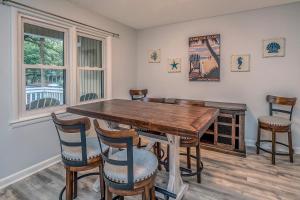 a dining room with a wooden table and chairs at 545 Tarpon Pond Cottage in Seabrook Island +28 photos