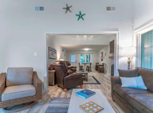 a living room with a couch and chairs and a table at 545 Tarpon Pond Cottage in Seabrook Island