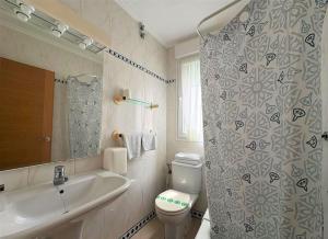 a bathroom with a sink and a toilet and a shower at Hotel Pineda Playa in Noja +74 photos