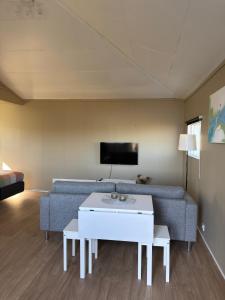 a living room with a couch and a table at Krókur Guesthouse in Patreksfjörður