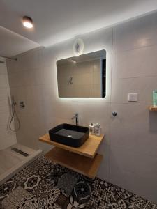 a bathroom with a black sink and a mirror at Aegean Infinite View-Beachfront Suite Pelion in Chorefto +37 photos