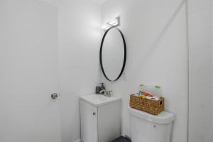 a bathroom with a mirror above a toilet at 11430 Lincoln Blvd in Richmond Heights