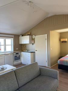 a living room with a couch and a kitchen at Krókur Guesthouse in Patreksfjörður