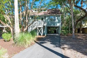 a house with a walkway in front of it at 507 Tarpon Pond Cottage in Johns Island