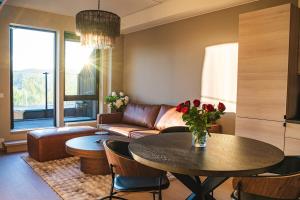 a living room with a couch and a table at Modern apartment with balcony and view in Trondheim +18 photos