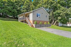 a house on the side of a grassy hill at Cozy Corner in Oswego