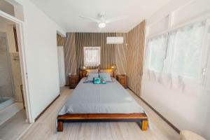 a bedroom with a large bed in a room at Haut de lolo in Garnier +4 photos