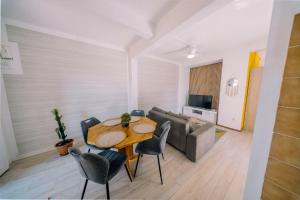 a living room with a table and a couch at Haut de lolo in Garnier