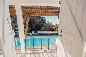 a view from the door of a house with a swimming pool at Haut de lolo in Garnier