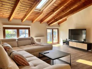 a living room with a couch and a flat screen tv at Kantauri Homes- KAI in Bermeo