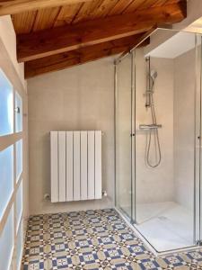a bathroom with a shower with a glass door at Kantauri Homes- KAI in Bermeo +42 photos