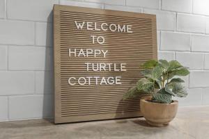 a sign that says welcome to happy little coffee at 1128 Summerwind Cottage in Seabrook Island