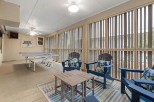 a room with a ping pong table and chairs at 1128 Summerwind Cottage in Seabrook Island