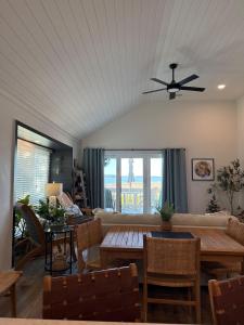 a living room with a ceiling fan and a table at 1338 Pelican Watch Villa in Seabrook Island
