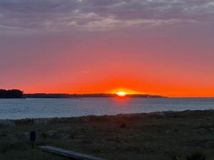 a sunset over a body of water with the sun setting at 1338 Pelican Watch Villa in Seabrook Island
