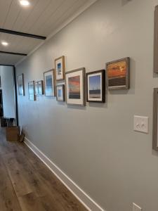 a wall with a bunch of pictures on it at 1338 Pelican Watch Villa in Seabrook Island