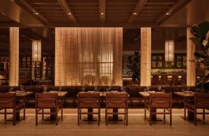 a restaurant with tables and chairs in a room at Hotel Nelligan in Montreal +55 photos