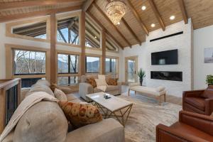 a large living room with a couch and a fireplace at Luxury Log Cabin with lake view in Black Mountain