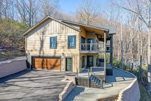 a large house with a garage in the woods at Luxury Log Cabin with lake view in Black Mountain