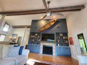 a living room with a couch and a surfboard on the wall at 2264 Seascape Crt. in Seabrook Island