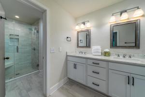 a bathroom with two sinks and a shower at 2264 Seascape Crt. in Seabrook Island