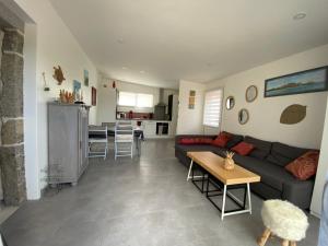 a living room with a couch and a table at Gite du Becquet in Le Rozel +8 photos